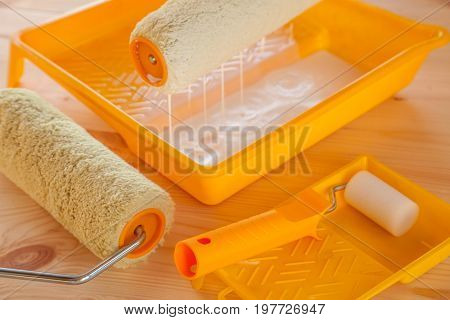 1245569 Paint Roller Brush With White Paint On Wooden Background
