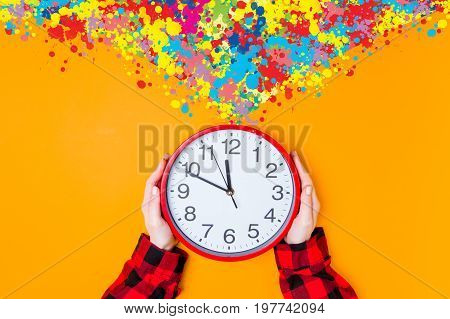 Female Hands Holding Huge Clock With Color Inpiraton