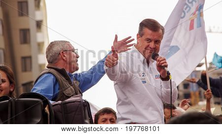 Quito, Ecuador - April 7, 2016: Closeup opposition leader Andres Paez talking with a microphone and surrounded by people and journalists during anti government protests in Shyris Avenue.