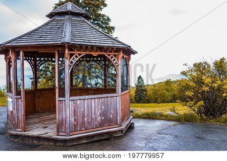 Closeup Of Brown Empty Gazebo In Autumn Landscape Overlooking Coast