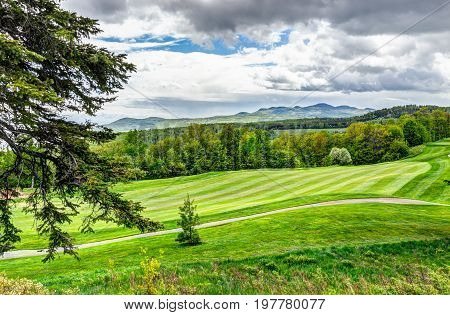 Landscape View Of Green Golf Course With Hills In Summer In La Malbaie, Quebec, Canada In Charlevoix
