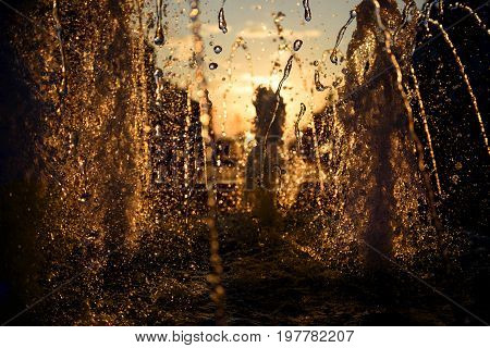 Water blurred splash in sunset light background