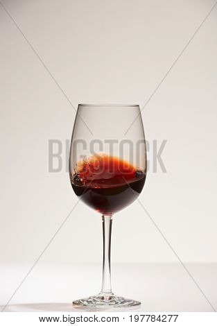 Smooth surface of red wine shaking in glass. Red wine in glass
