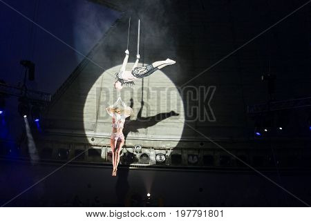 Stunt aerialists men and women in the circus. Love, danger, and romance concept.