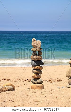 Stones Piled On Top Of One Another In Inuksuk Fashion