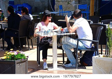 VITTORIOSA, MALTA - MARCH 31, 2017 - Couple relaxing at a pavement cafe along the waterfront Vittoriosa (Birgu) Malta Europe, March 31, 2017.