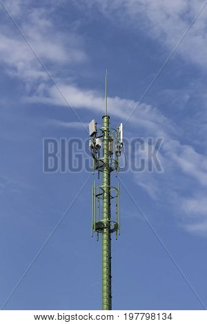 antenna supporting tower with white cloudy sky
