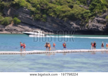 Tourists walking on the floating pair near the beach on the islands in Thailand Blurry images.
