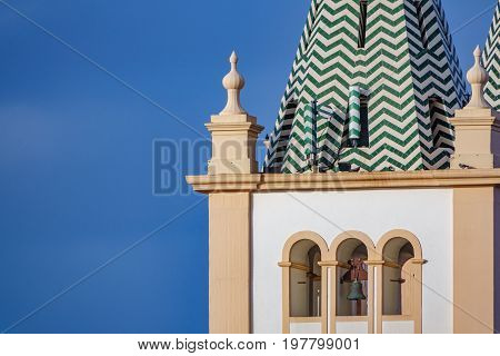 Long shot view of church belfry in Angra do Heroismo with sky in the background, Island of Terceira in Azores, Portugal