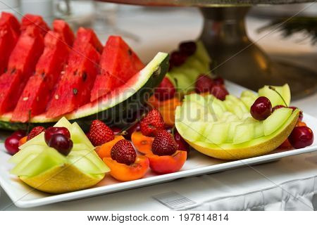 Heap of fresh fruits and vegetables on table close up.