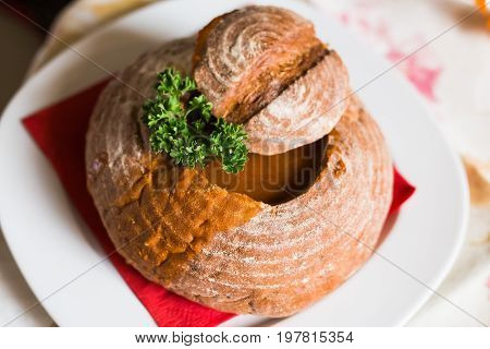 Goulash soup in bread served in a bread bowl.