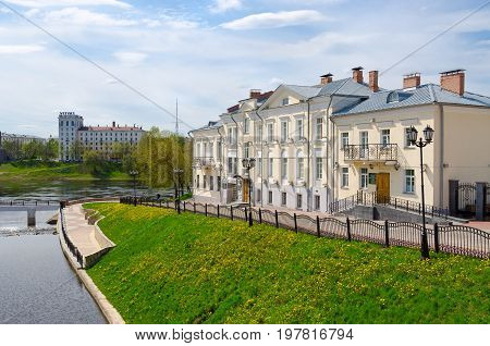 VITEBSK BELARUS - MAY 15 2017: Unknown people walk along embankment near Holy Spirit monastery at rivers Zapadnaya Dvina and Vitba Vitebsk Belarus