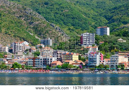 RAFAILOVICI MONTENEGRO - SEPTEMBER 19 2015: View from sea to popular resort village of Rafailovici (Hotel Obala Plus 3* Apartment Lux Tri Ribara 4* fish restaurant Tri Ribara) Montenegro