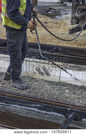 Road Worker Spraying Manually Bitumen Emulsion 2