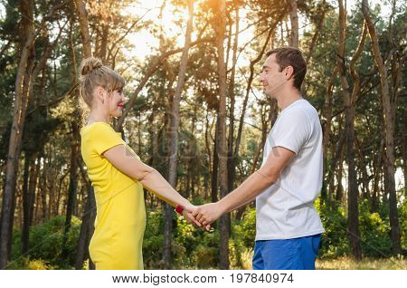 happy young couple holding hands in the park