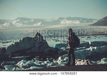 Woman explorer lookig at Jokulsarlon lagoon, Iceland.