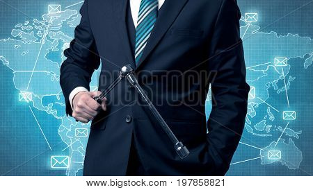 Businessman holding tool with global map graphic on the background
