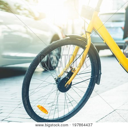 closeup of a shared bicycle parked on sidewalk