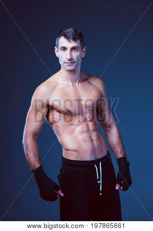 portrait of hand wrapping half nude boxer.