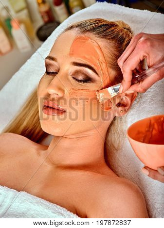 Collagen face mask. Facial skin treatment. Face of woman receiving cosmetic procedure in beauty salon close up number one isolated. Mask against sagging skin.
