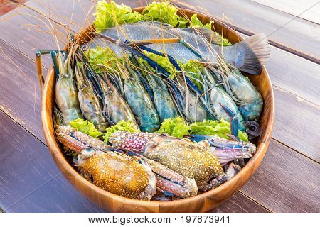 Raw Seafood set ready to cook on wooden table