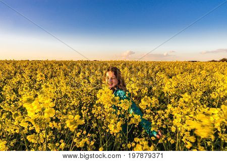 Teenage Girl With Long Hair In Yellow Bittercress Field