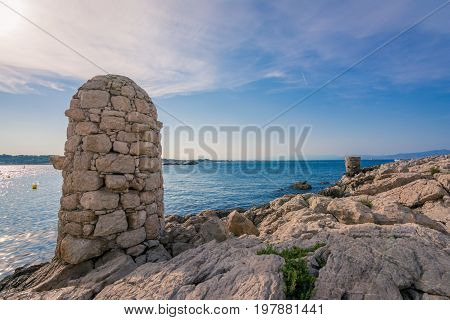 Old stone mooring post in l'Escala, costa brava, Spain. Two stone constructions that used to tie the cabin boats, which could not reach de beach.