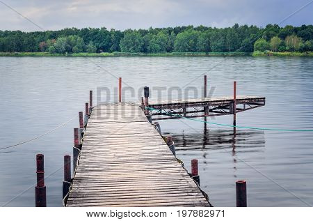 Wooden pier on the lake. Afternoon landscape on the lake.