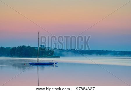 Boat on the water. Evening landscape by the lake.