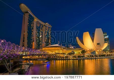 SINGAPORE - JUNE 17 2014 : Marina Bay Sands and Lotus building during twilight time in Singapore