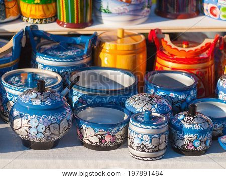 Russian national wooden utensils at the fair. Traditional Russian souvenir. Kitchen Decor.