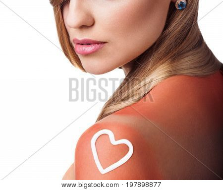 Sunblock on the female shoulder isolated on white. Body care concept.