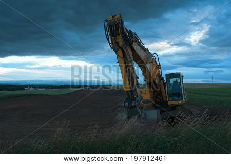 Excavator in the evening on the construction site