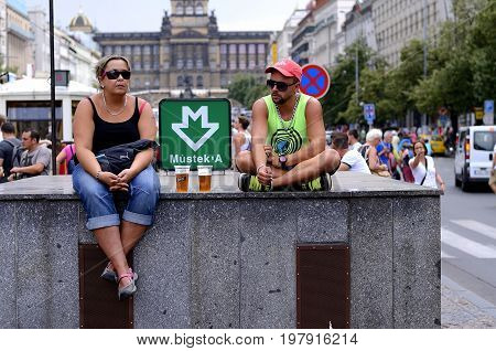 Prague, Czech Republic, 15 August, 2015, Editorial photo of man and woman who is waiting for on the wall of metro station, Prague, Czech Republic, St. Wenceslaus square