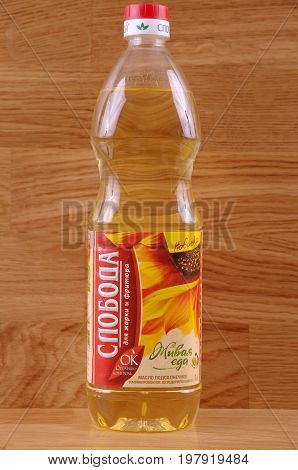SARANSK, RUSSIA - AUGUST 01, 2017: Sloboda sunflower oil on wooden background. Sloboda brand owned by EFKO Group.
