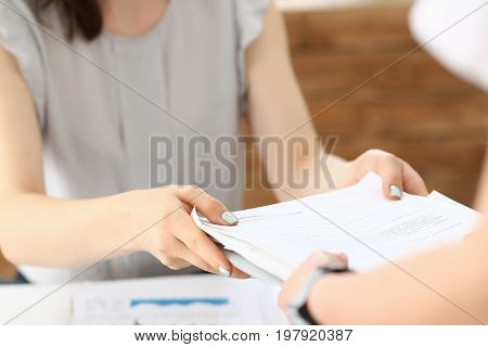 Female Employee Show Pack Of Documents To Manager