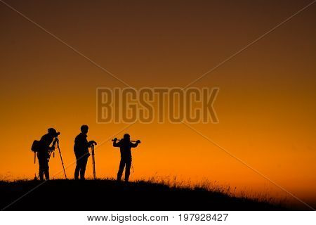 Silhouette of aphotographers top of mountain on sunset. At Doi-Monjong Chiangmai Thailand