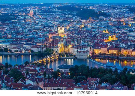 Prague at twilight blue hour view of Charles Bridge on Vltava with Mala Strana and Old Town.