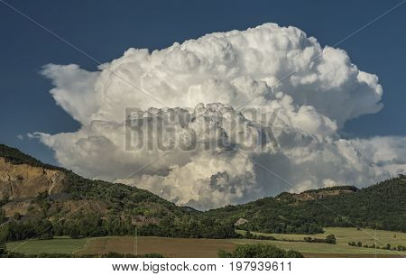 Big white cloud over valley of river Labe with blue sky