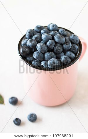 Fresh Ripe Blueberry In Mug On White Table.
