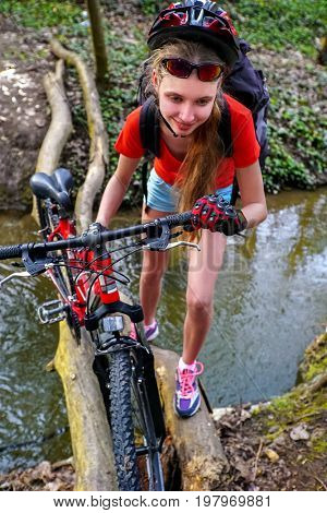 Bikes cycling girl. Girl rides bicycle. Girl cycling fording throught water. Cycling trip is good for health. Cyclist watch your step. View from above.