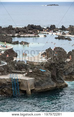 PORTO MONIZ MADEIRA PORTUGAL - SEPTEMBER 5 2016: Natural rock pool of Porto Moniz. It is a public bath with water from the Atlantic Ocean.
