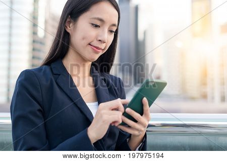 Business woman looking at mobile phone