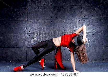 Girl dancing in front of the urban wall.