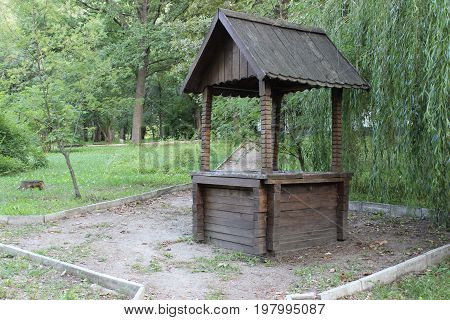 Old wooden well in the city park