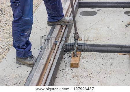 Rail Worker Tightening A Bolt