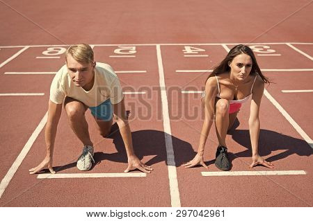 Equal Forces Concept. Man And Woman Low Start Position Running Surface Stadium. Running Competition 