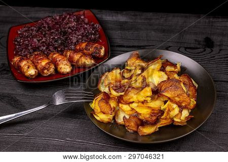 Fried Homemade Grilled Sausages Or Chevapchichi With Stewed Sauerkraut On A Wooden Rustic Background