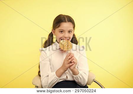 Lollipop Child. Child Eating Lollipop In Yellow Studio. Lollipop Child Eating Candy With Happy Face.