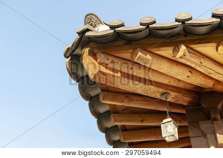 Architectural Details Of Wooden Eaves And Ceramic Tile Roof Ends Of A Tradition House At Korean Anci